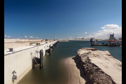 The quaywalls for RWG are complete, with dredgers removing sand from the basins. Photo: PRA